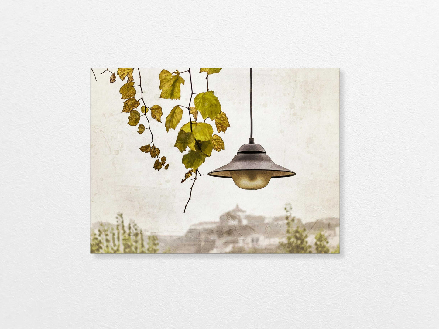 Light bulb hanging above with a view of Porto in the background, featuring trees and buildings.