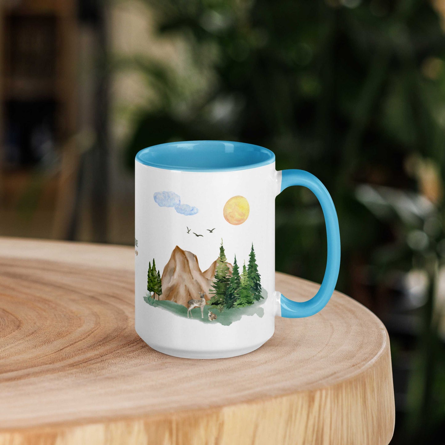 Ceramic Mug featuring a nature scene with trees, mountains, and a deer.