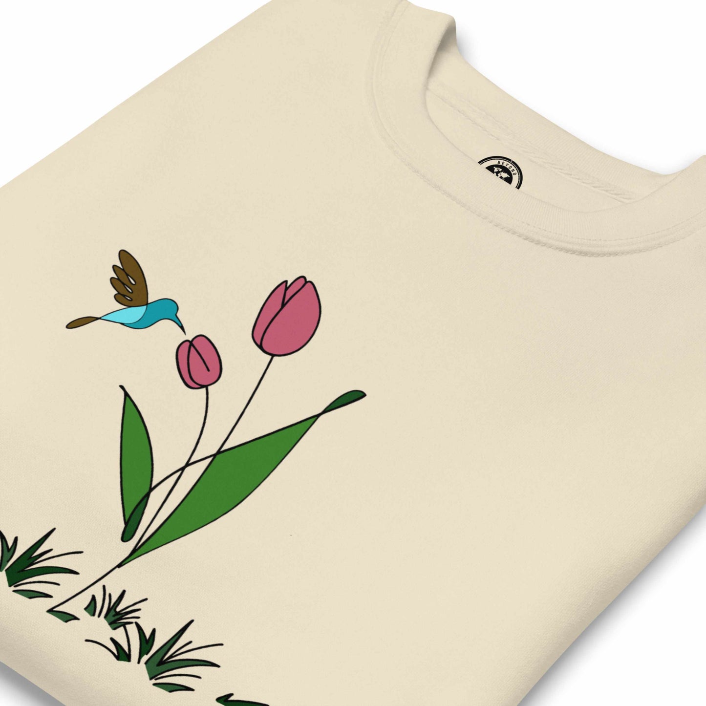 Fresh Feeling design captures a fleeting moment of harmony. Beige sweatshirt with a floral, hummingbird and tulip design.
