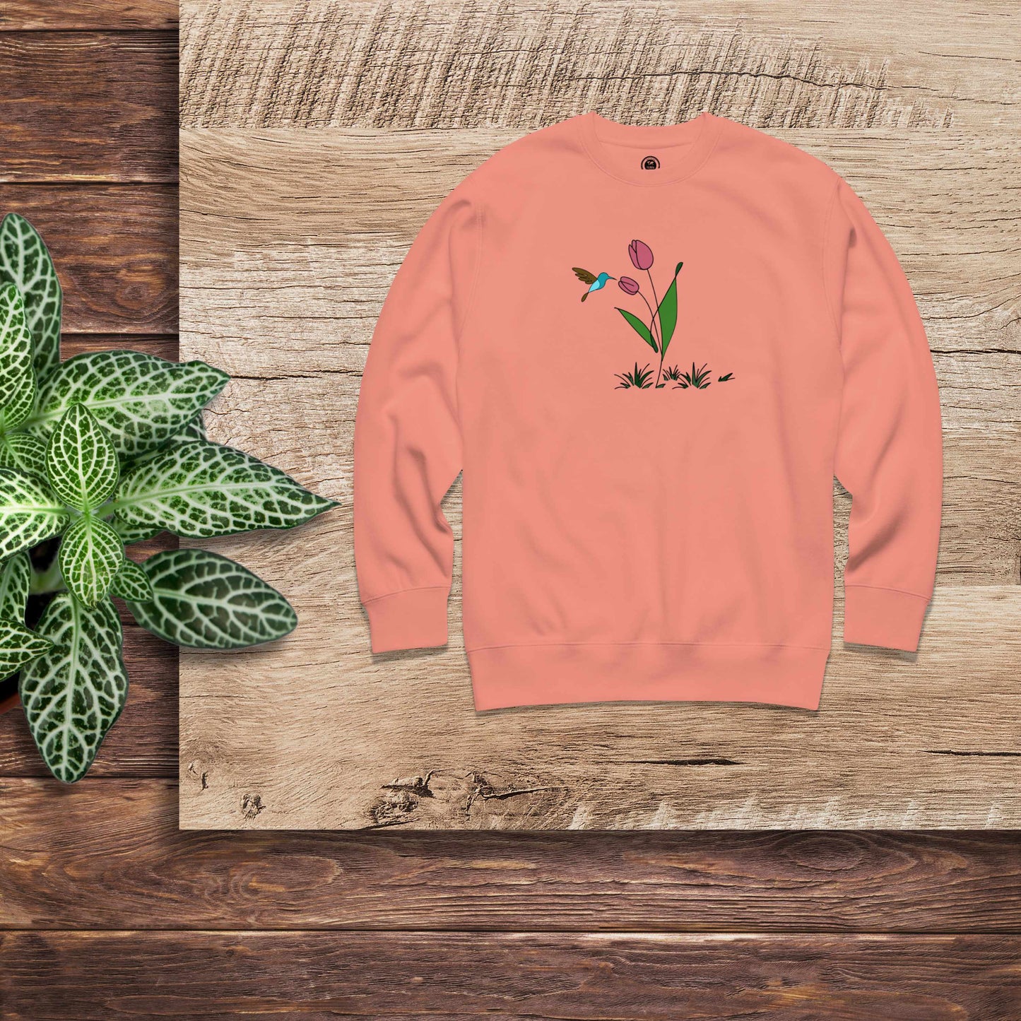 Fresh Feeling design captures a fleeting moment of harmony. Sweatshirt with a floral, hummingbird and tulip design.