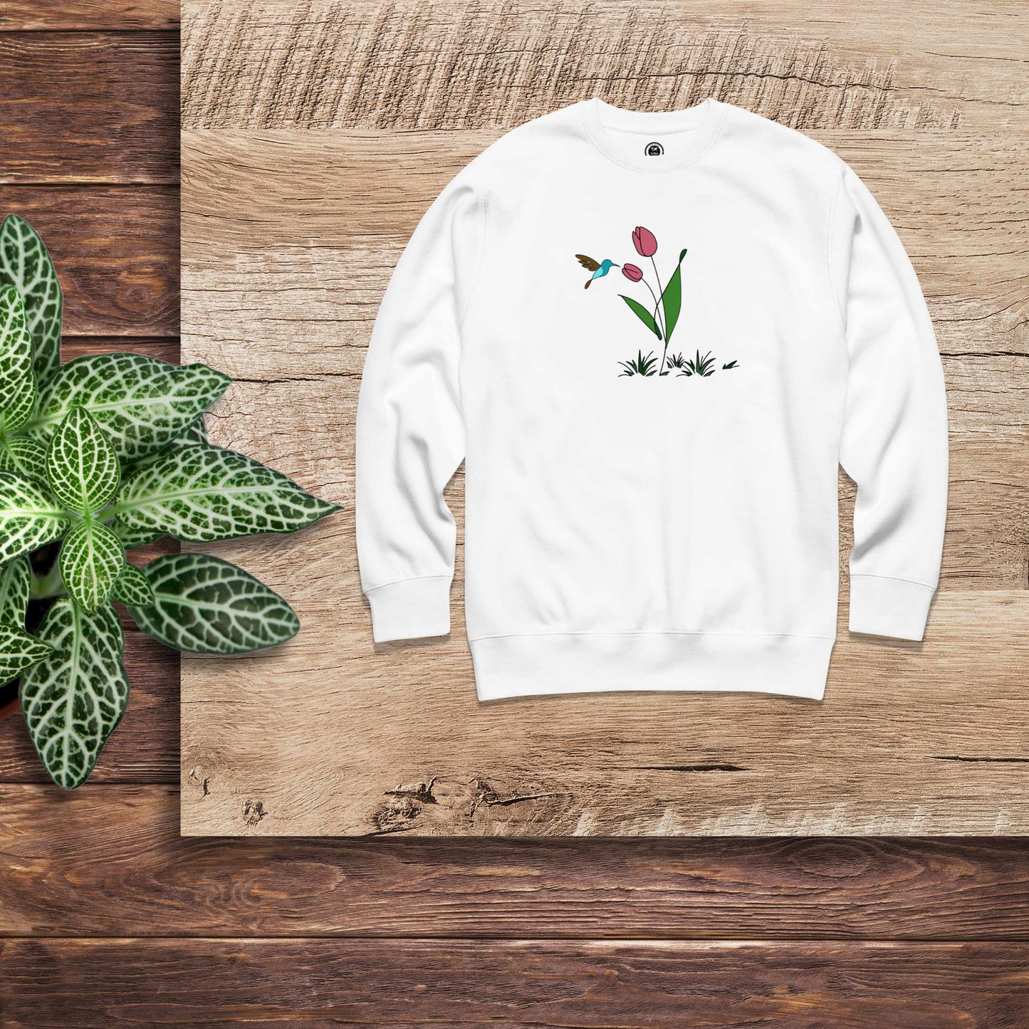 Fresh Feeling design captures a fleeting moment of harmony. White sweatshirt with a floral, hummingbird and tulip design.