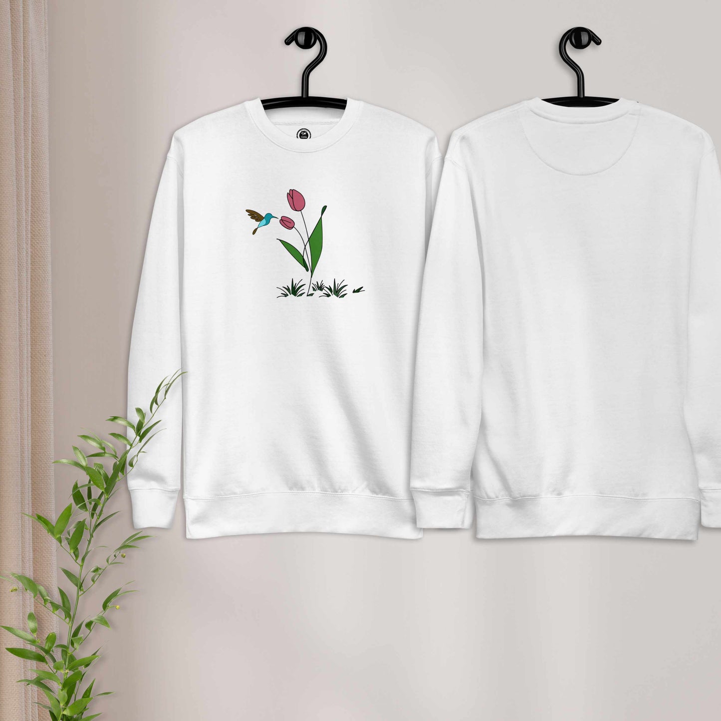 Fresh Feeling design captures a fleeting moment of harmony. White sweatshirt with a floral, hummingbird and tulip design.
