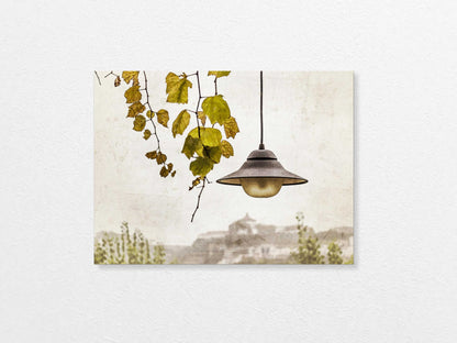Light bulb hanging above with a view of Porto  in the background, featuring trees and buildings.