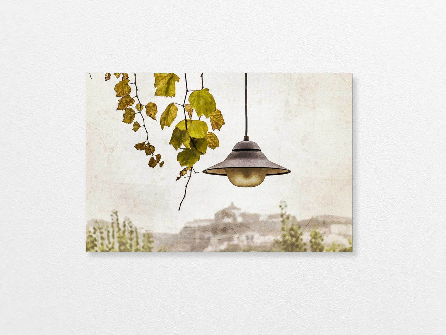 Light bulb hanging above with a view of Porto  in the background, featuring trees and buildings.