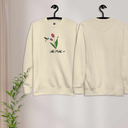 Fresh Feeling design captures a fleeting moment of harmony. Beige sweatshirt with a floral, hummingbird and tulip design. 