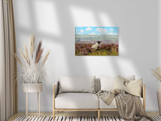 Living room with a sofa, decorative plants, and a wall art of a sheep in a field.